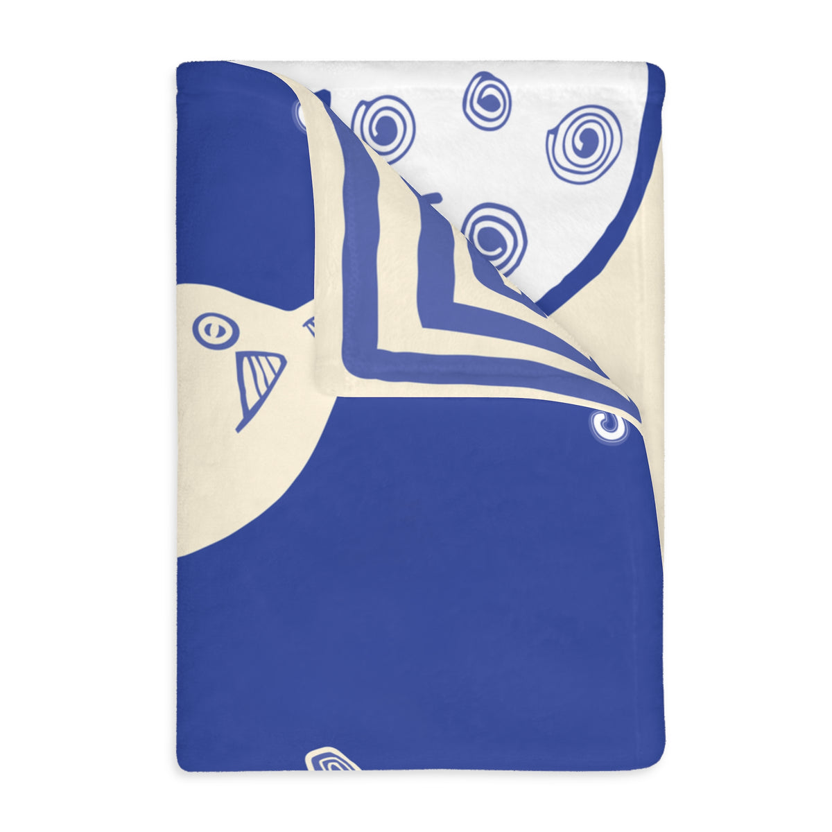 Colombian Dreams blanket folded at the corner, blue with a cream line-art cat face and a white back with blue spirals
