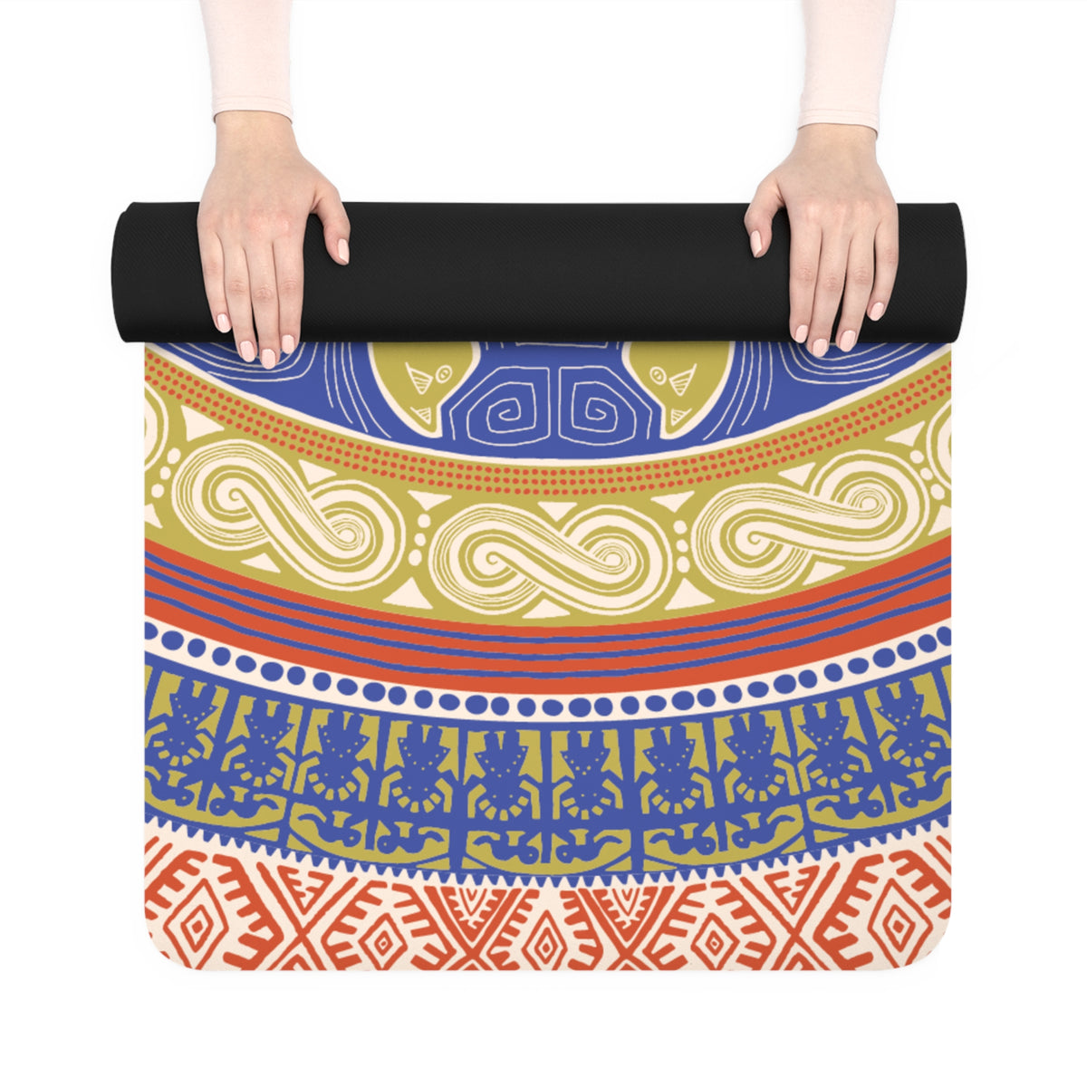 Hands unrolling the Colombian Dreams Mandala Circle yoga mat, showing blue, olive and red geometric bands