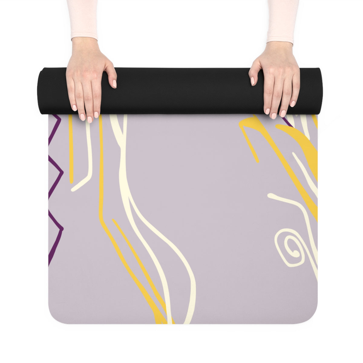 Hands unrolling the lilac Queen of Phoenix yoga mat with yellow, cream and purple line art and black underside