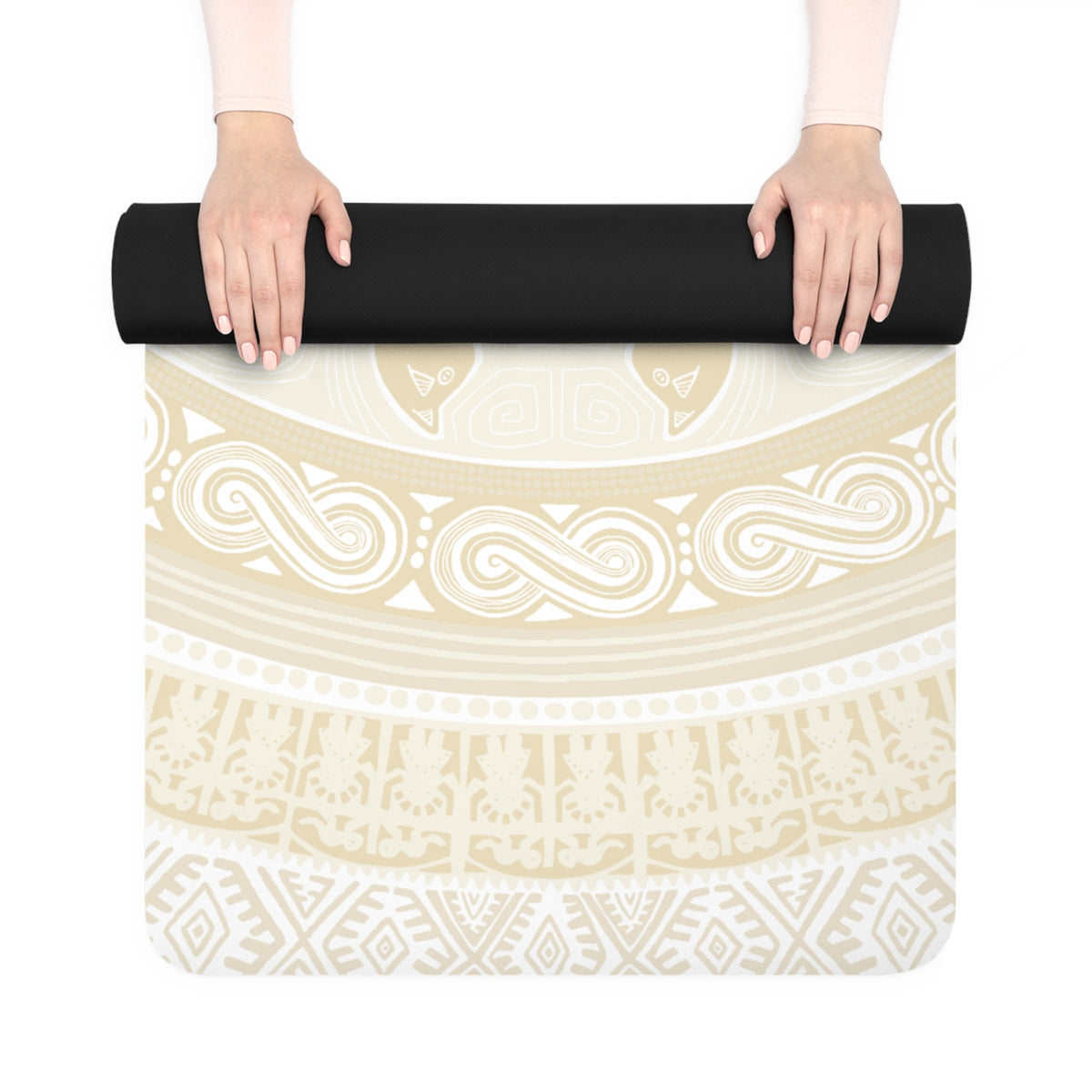 Hands unrolling the Colombian Dreams beige mandala yoga mat, black underside visible on the roll