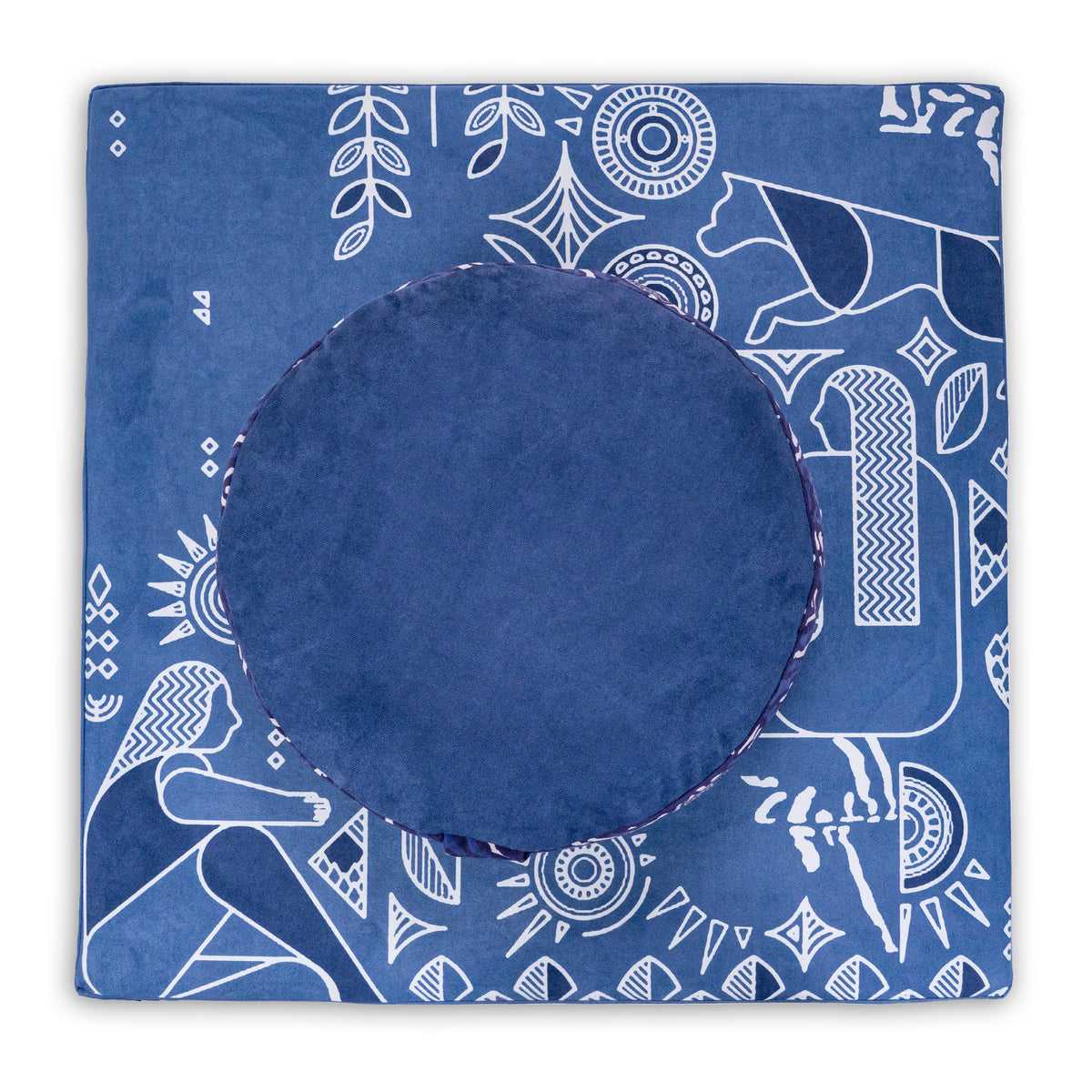 Round navy blue meditation cushion on a square blue Royal Court mat with white line-art figures and animals