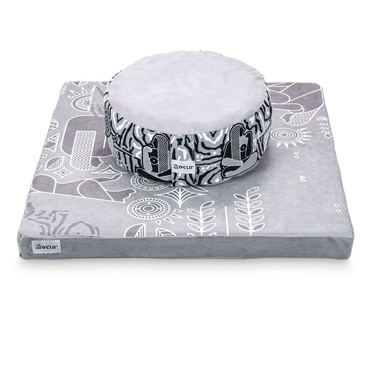 Royal Court round meditation cushion with black and white side print resting on a gray square mat with white line-art pattern
