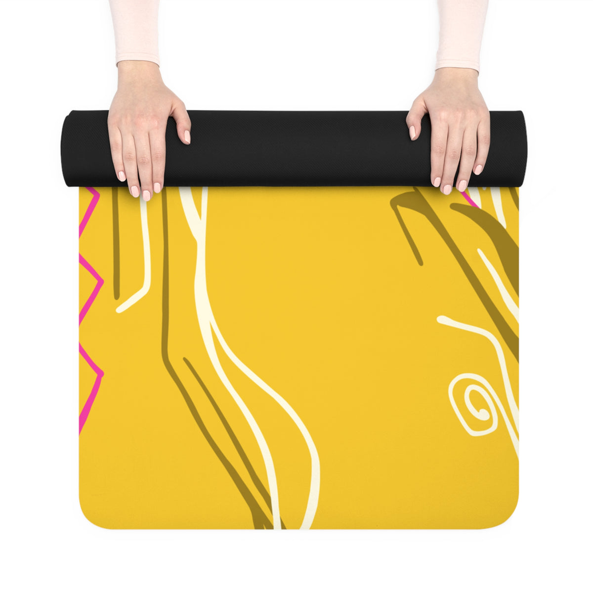 Hands unrolling the yellow Queen of Phoenix yoga mat, showing pink zigzag and cream line art and black underside