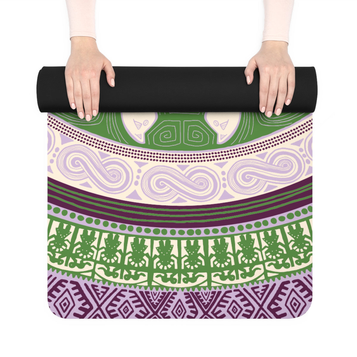 Hands unrolling the Colombian Dreams Mandala Cats yoga mat, showing green, cream and plum pattern bands