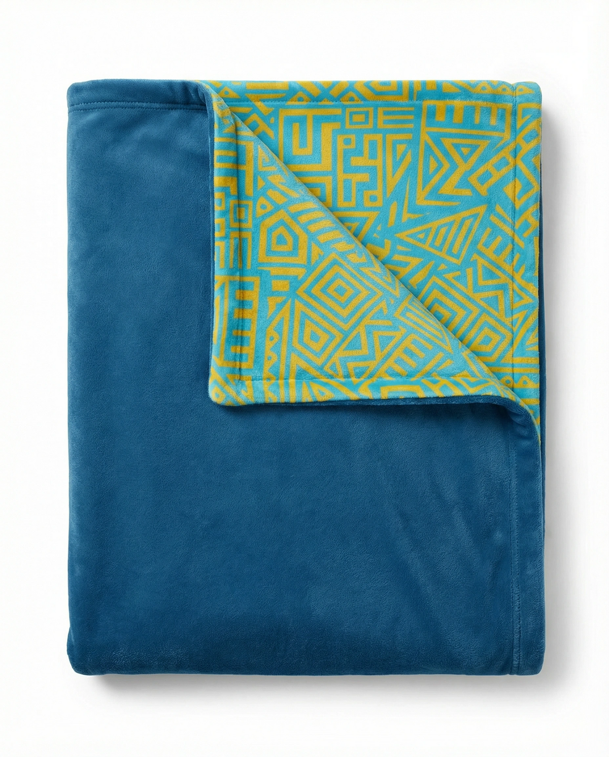Dancing Ladies blanket folded to show a teal velvet side and a turquoise and yellow geometric pattern reverse