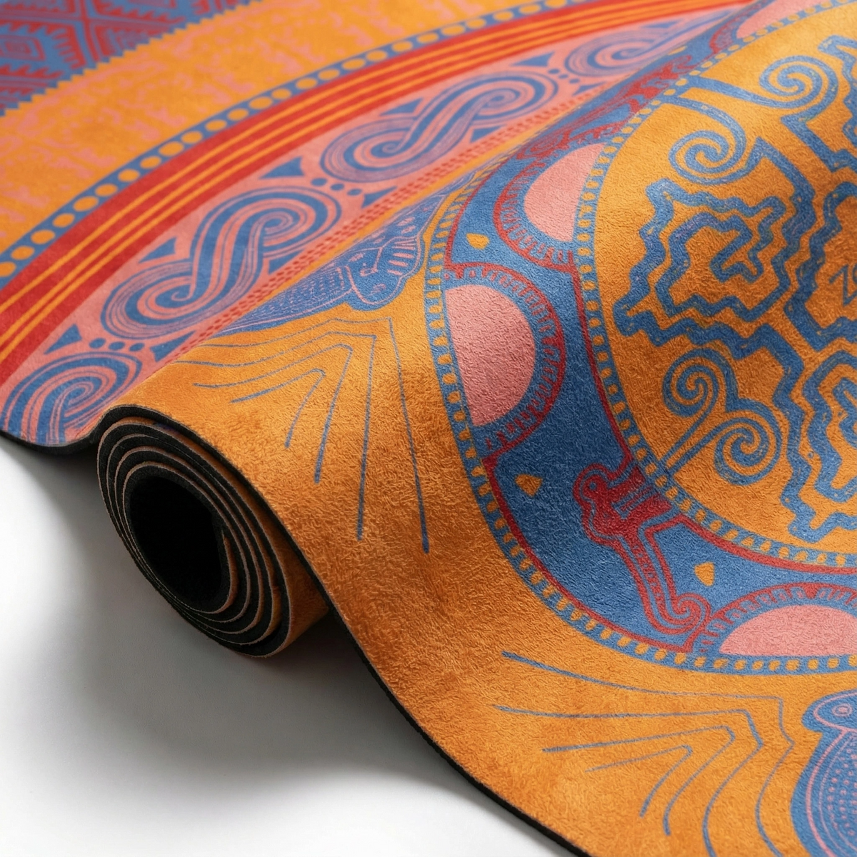 Orange Colombian Dreams yoga mat partly rolled, showing the coral and blue wave border and black underside