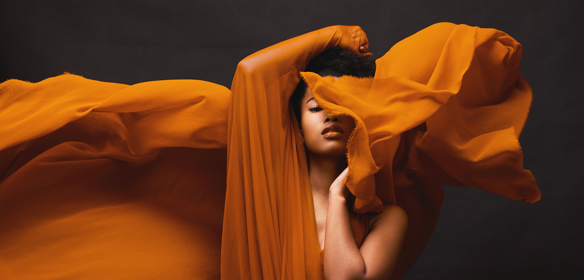 Copper-colored yoga dress displayed on floor