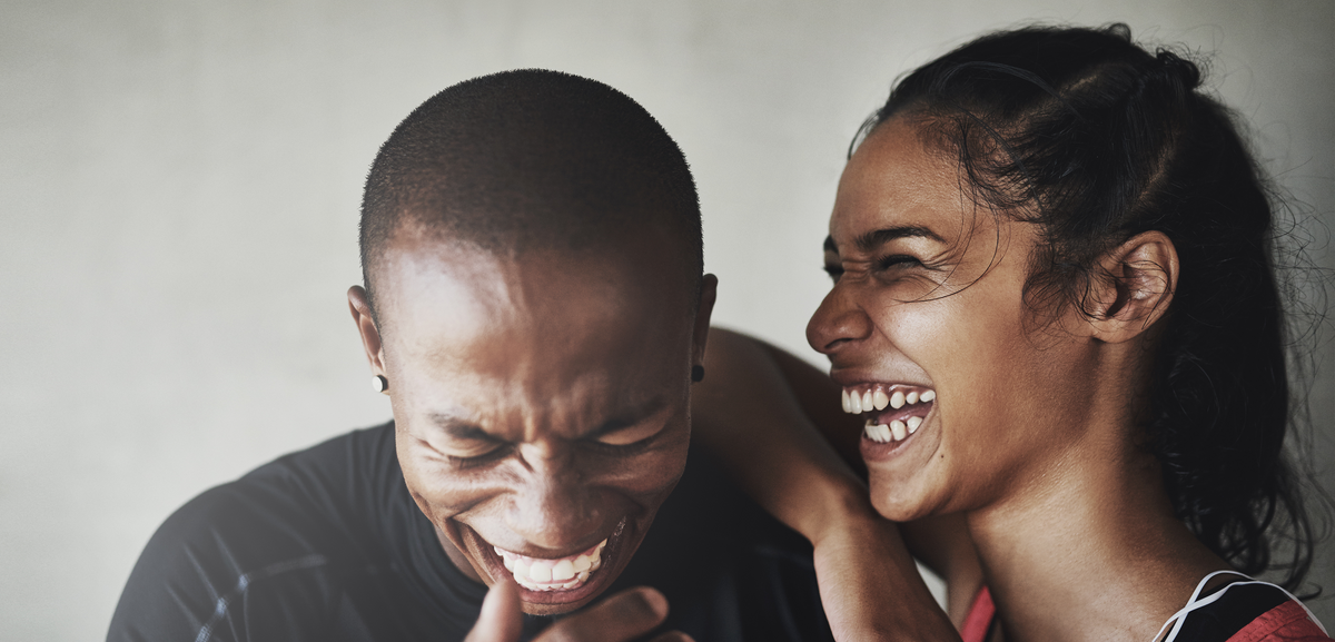 Two people laughing together in casual setting