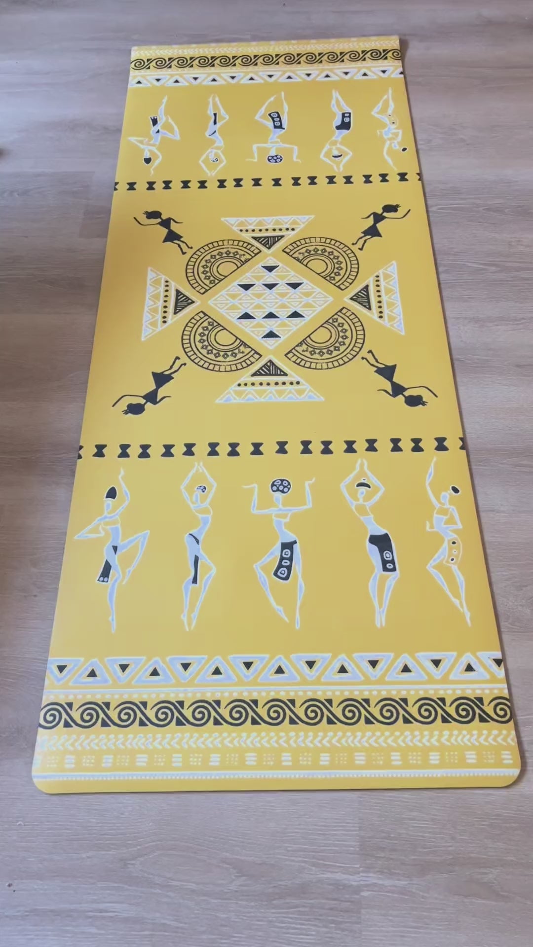Dancing Ladies PU yoga mat video: the yellow mat laid flat, a woman moving through standing poses on it at home