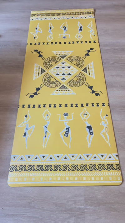 Dancing Ladies PU yoga mat video: the yellow mat laid flat, a woman moving through standing poses on it at home