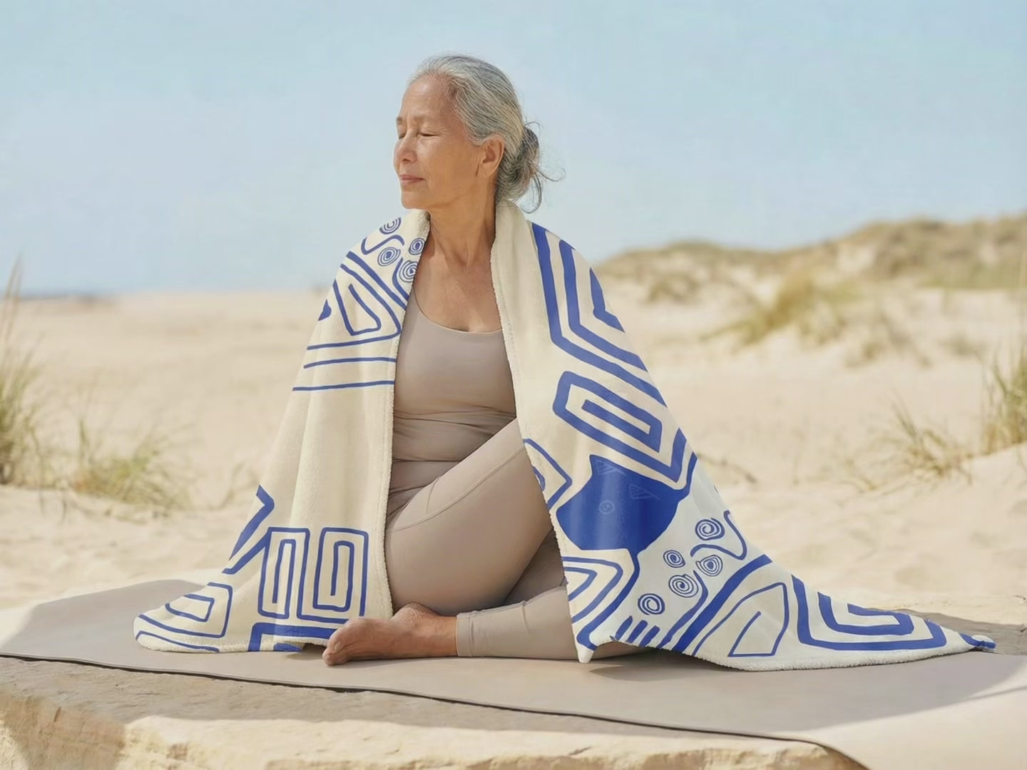 Colombian Dreams blanket video: cream, lilac, orange and ochre blankets worn and held open by dunes and a lake