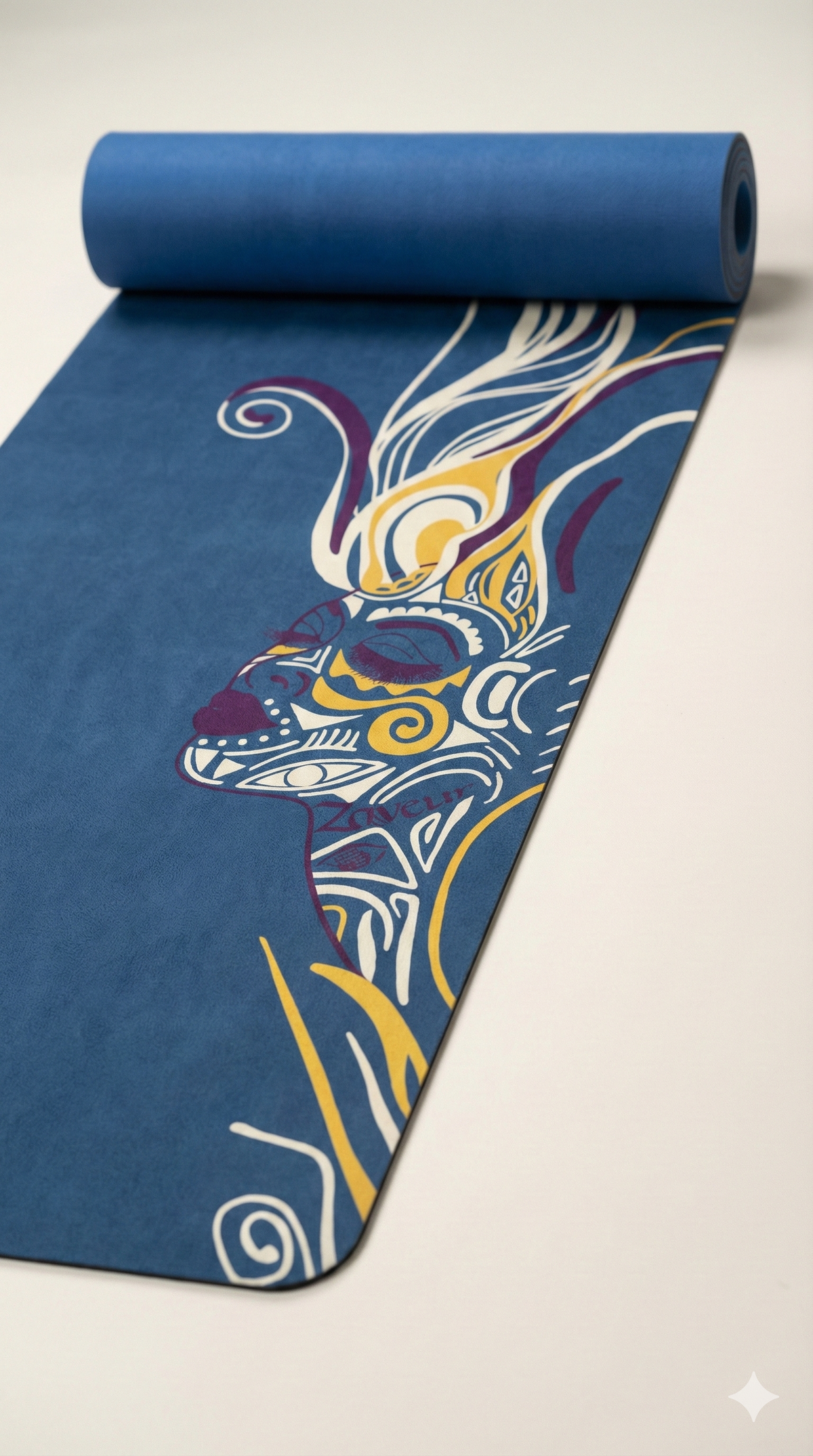 Zaveur blue yoga mat with artistic multicolor face illustration partially rolled on studio floor